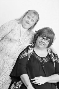Black and white image of two women modeling clothes for a fashion show